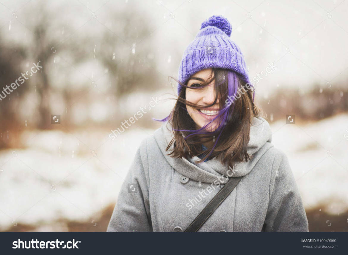 stock-photo-portrait-of-cute-happy-young-woman-in-purple-knitted-beanie-hat-and-gray-coat-outdoors-in-winter-510949060.jpg